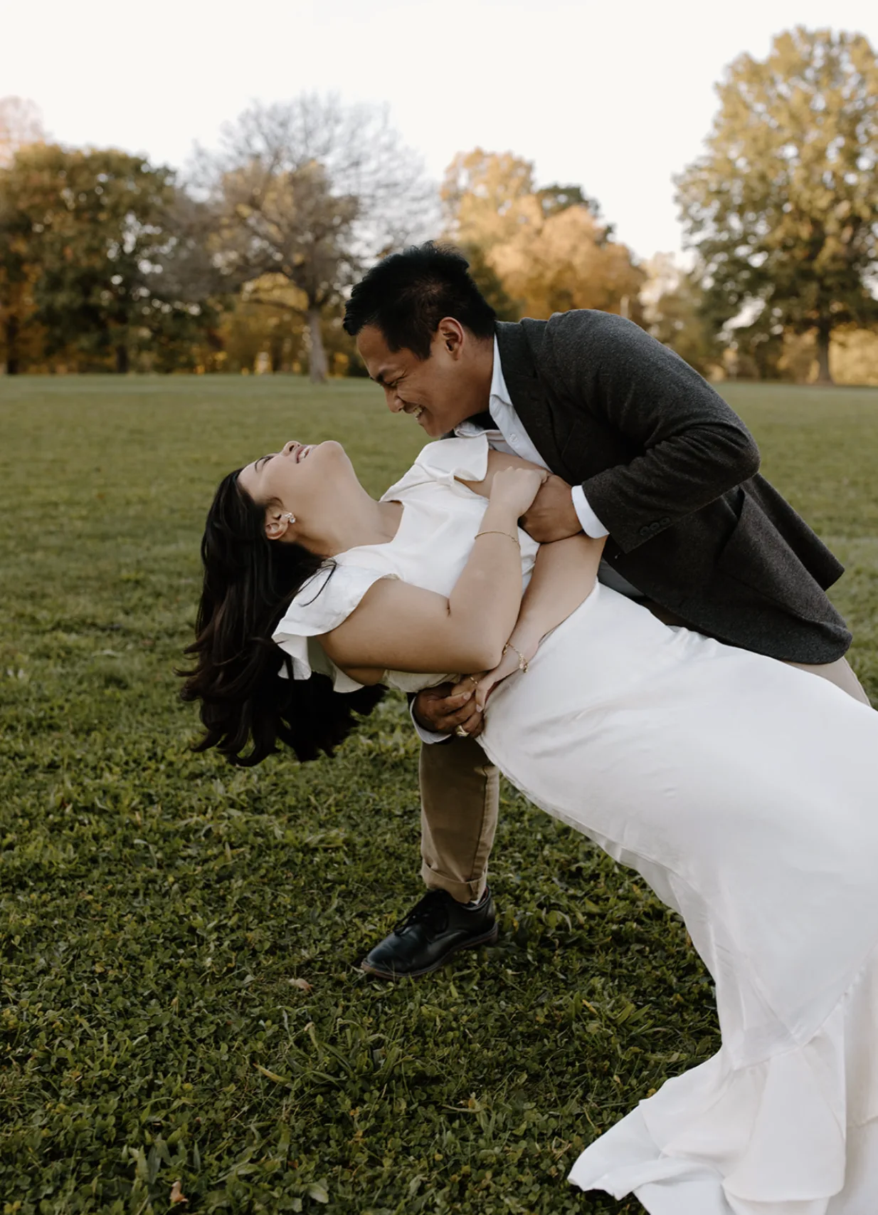 CQ dipping Carmela in a fall field as they both laugh