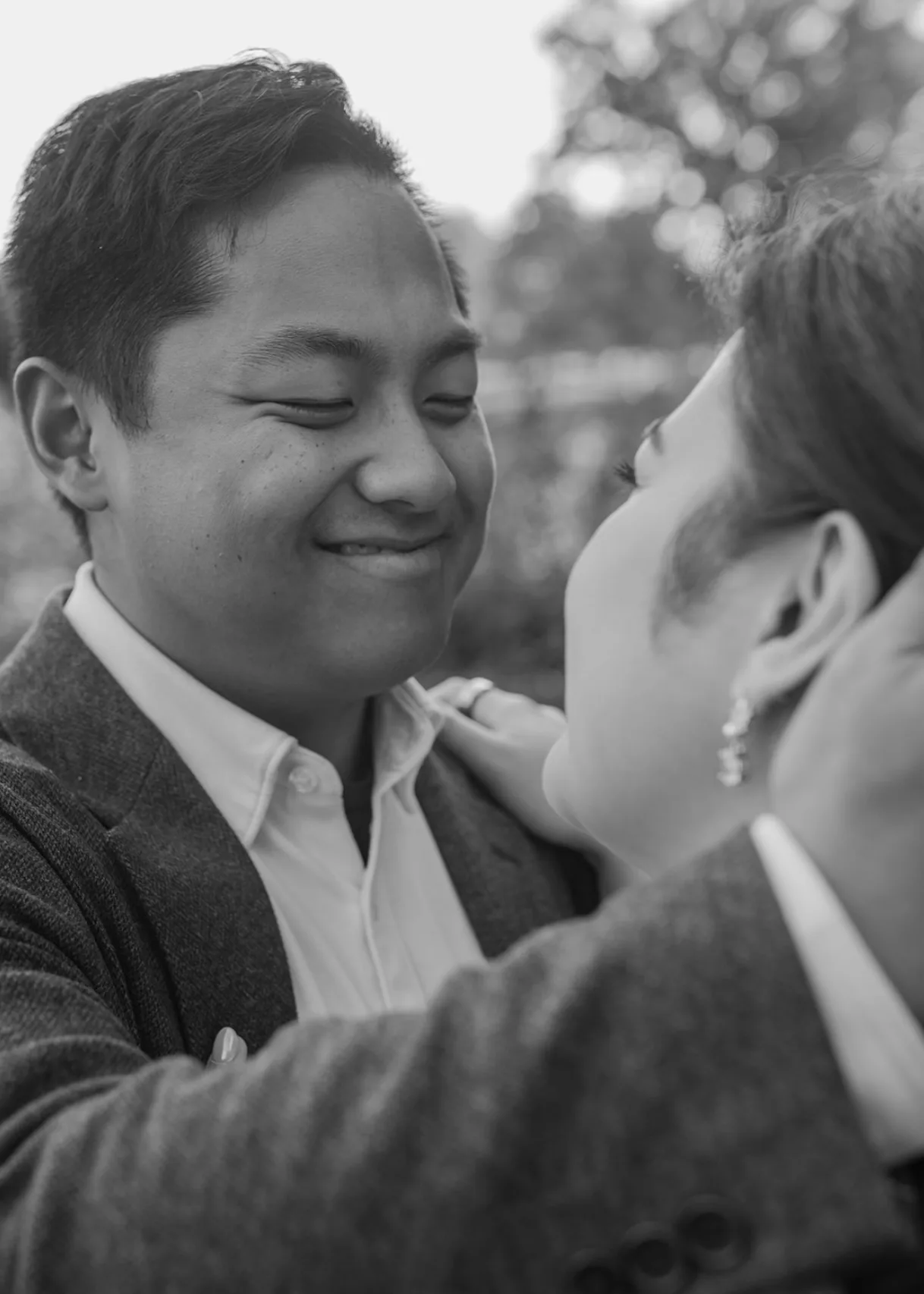 Black-and-white close-up of CQ smiling at Carmela