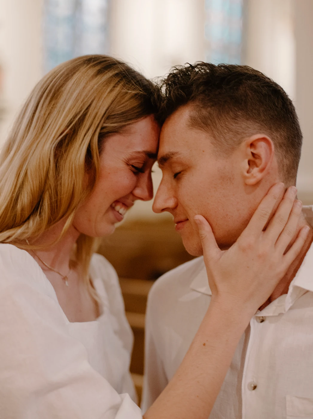 Close-up of the couple forehead to forehead, her hand on his cheek