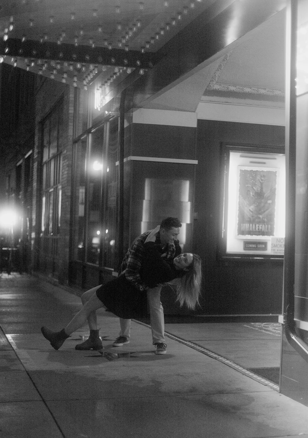 Black-and-white of Gerrin dipping Meredith on the sidewalk outside the theater